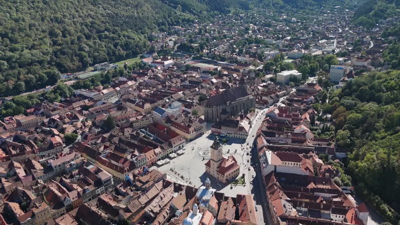 Aerial view of historic cityscape with red-roofed buildings and plaza