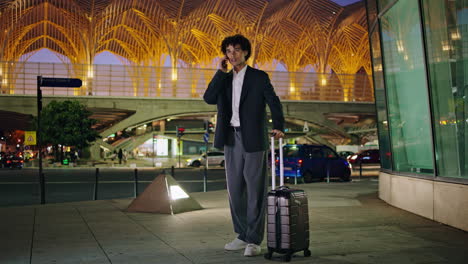 Young-manager-calling-taxi-dark-city.-Travelling-businessman-waving-hand-night