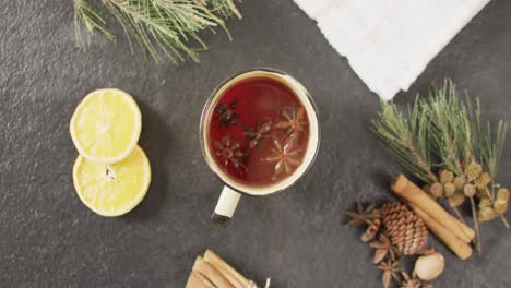 video of cup of hot tea with cinnamon and lemon over grey background