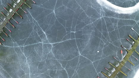 Cracked-Ice-At-Frozen-Lake-Of-Steinsfjorden-With-Wooden-Jetty-Of-Vik-Bathavn-At-Winter-In-Norway