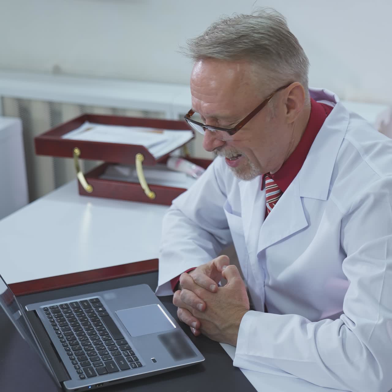Male doctor working at office desk