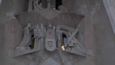 sagrada familia passion facade detail on the crucifixion close up tilt up 4k 30fps