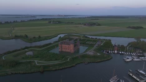 castle in medieval dutch muiderslot located in muiden during sunset, aerial