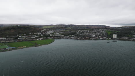 Greenock,-Scotland-on-a-windy-day-over-the-River-Clyde-slow-push-in-as-we-look-back-at-the-town