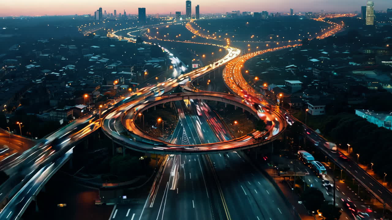A city street with a large roundabout in the middle. The street is busy with cars and trucks