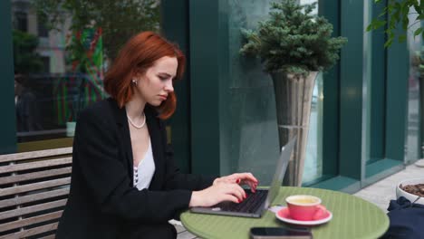 woman working on laptop in a cafe