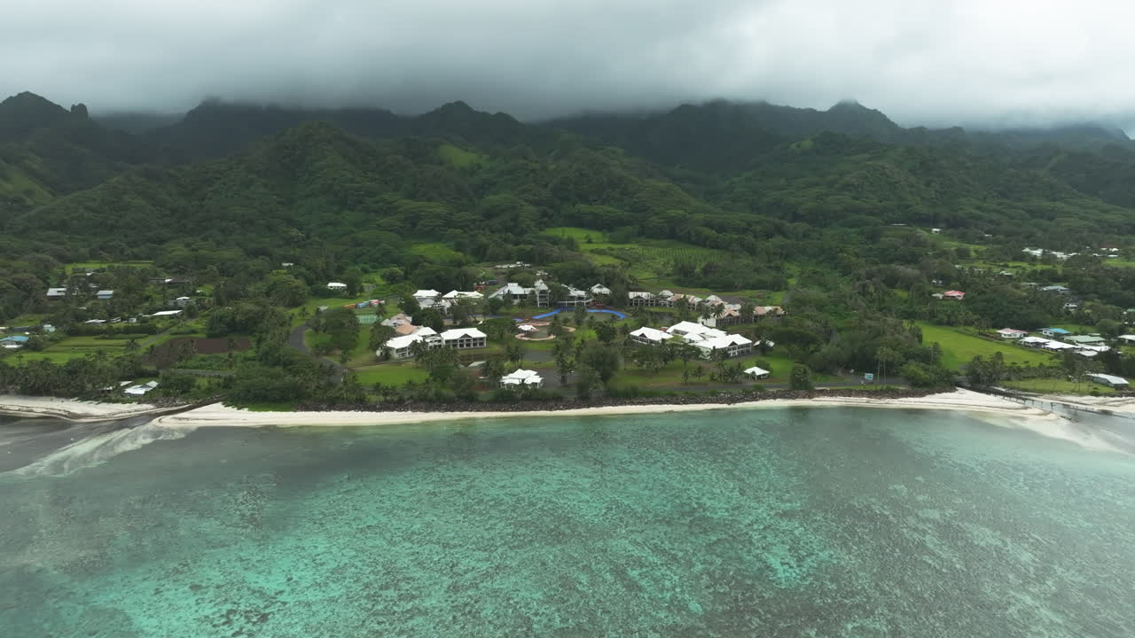 Moody spooky aerial drone establishing of abandoned hotel in Rarotonga Cook Islands