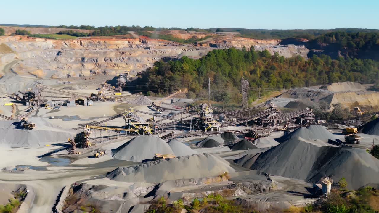 Drone medium orbit of aggregate processing plant and gravel piles of quarry in Arkansas USA