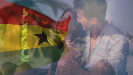 embracing on beach, couple with ghana flag animation overlay in vibrant colors