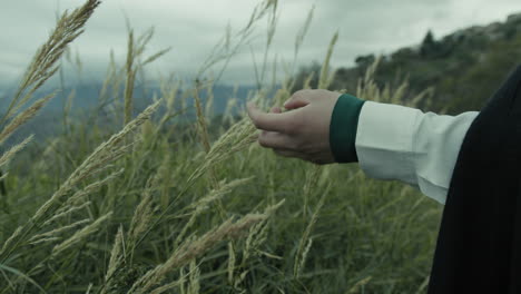 woman's hand touches ears in the countryside on a sad day of mourning