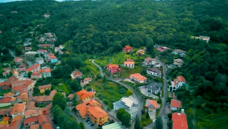 4k aerial drone video of mountainside farmhouses and vineyards in cavallasca, italy on a summer evening