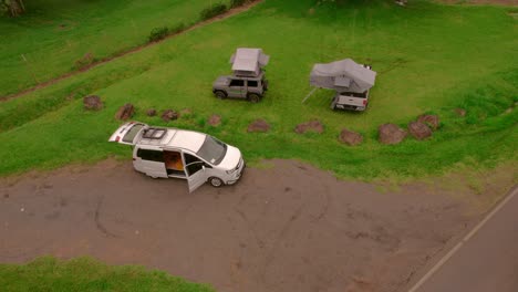 aerial drone shot of camping cars on a meadow