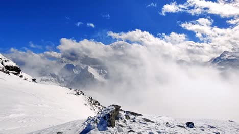 panning-shot-of-snowy-mountain-peaks-in-Austria-with-blue-skies