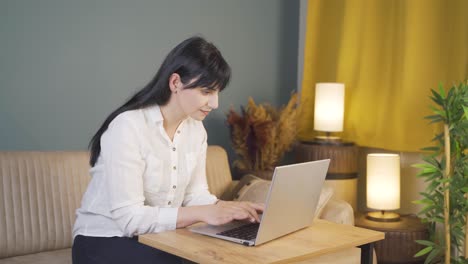 happy woman using laptop at night.