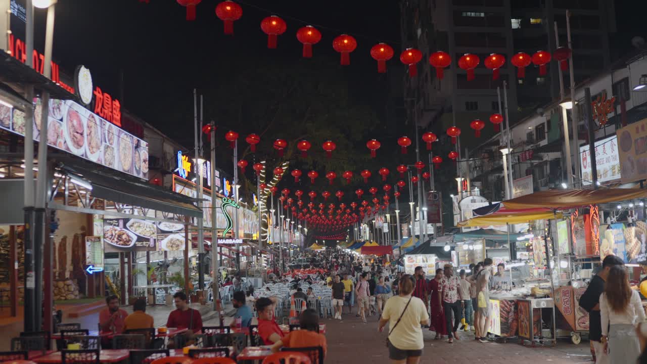 Night view of Petaling street with vendors on either side of it in Kuala Lumpur, Malaysia.