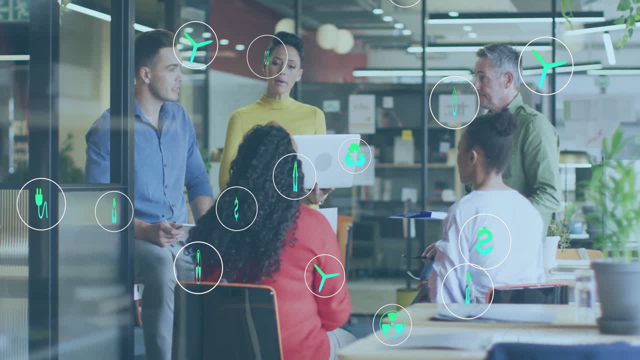 Animation of ecology icons over diverse colleagues discussing work in office