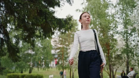 teenage girl walking in a park