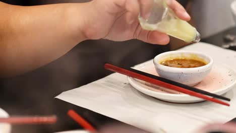 pouring sauce over food