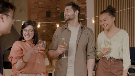 a nice multiethnic group of friends chatting and having fun at a dinner party