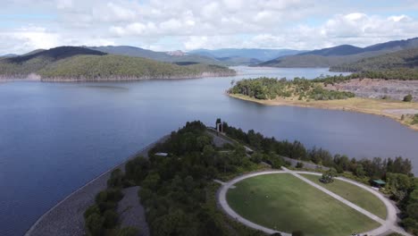 Flying-over-a-green-field-and-to-over-water-on-a-lake