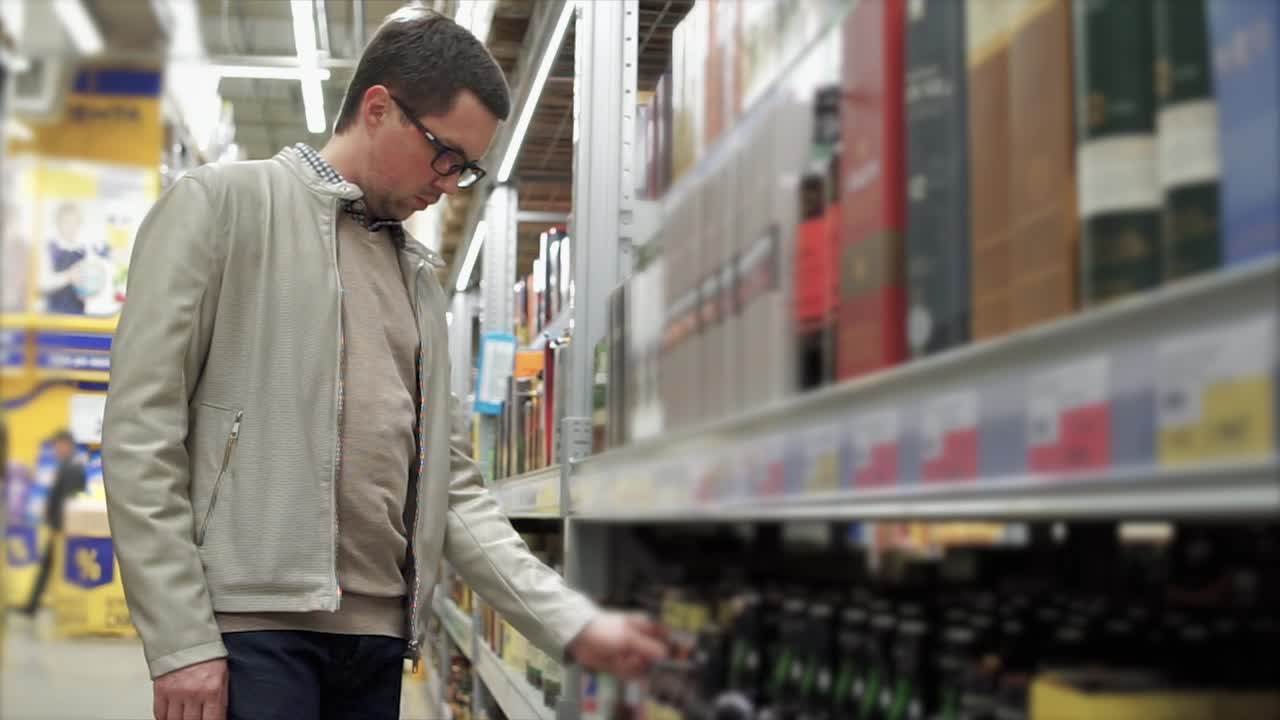 hombre comprando alcohol en una tienda de comestibles