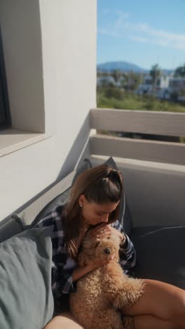 woman and her dog on a balcony