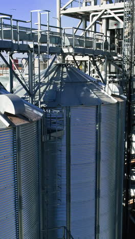 grain elevator. metal grain elevator in agricultural zone. aerial view. vertical video