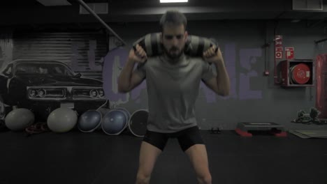 Young-athletic-man-doing-exercise-at-the-gym