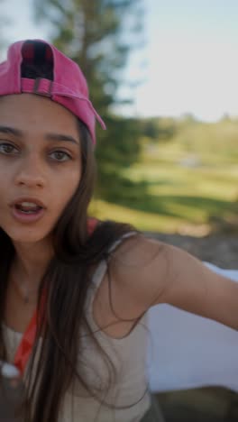 woman wearing pink baseball cap in park