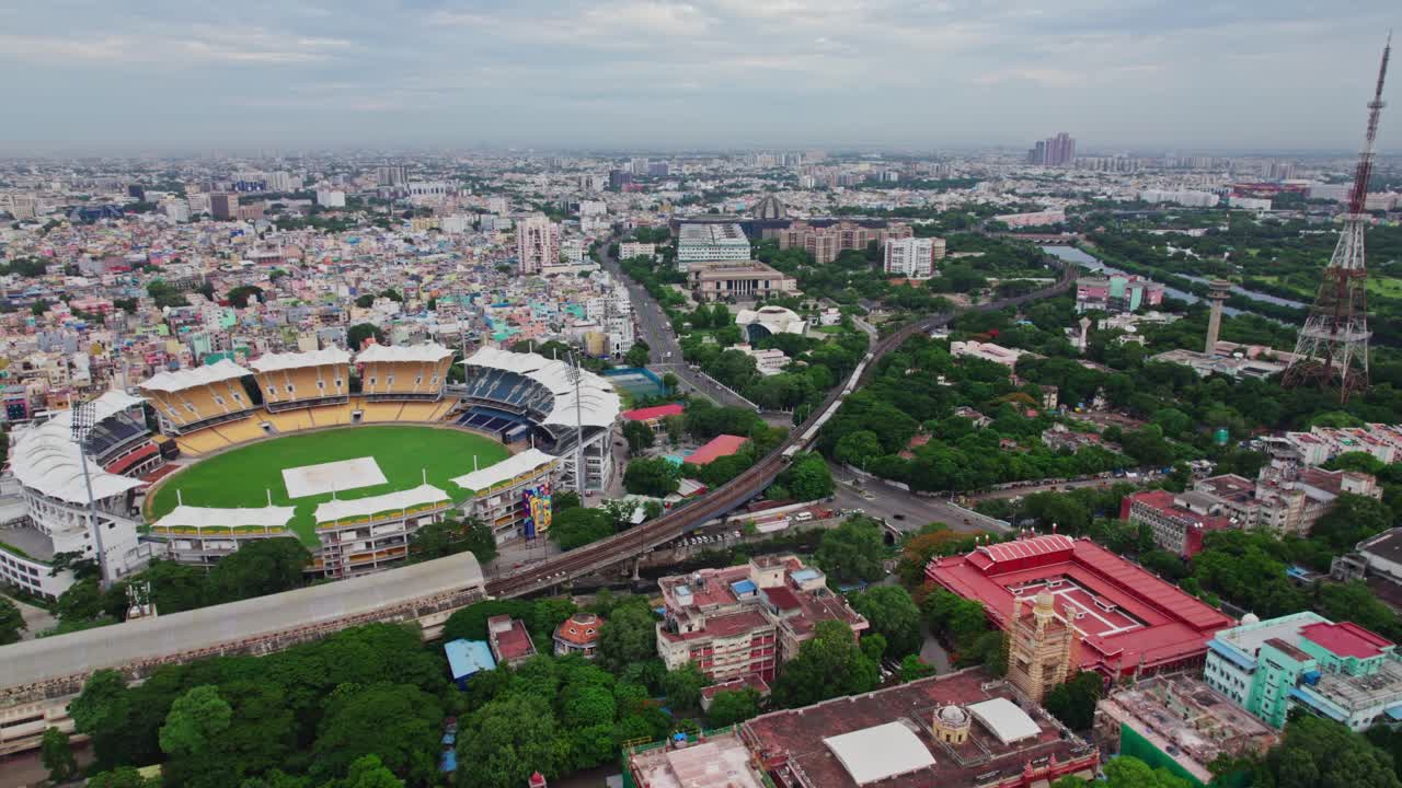 Madras Cricket Club with wallahjah road view, local train and chepauk railway station at Triplicane, Chennai, Tamil Nadu, india. day time, push back shot, drone shot, 4k.