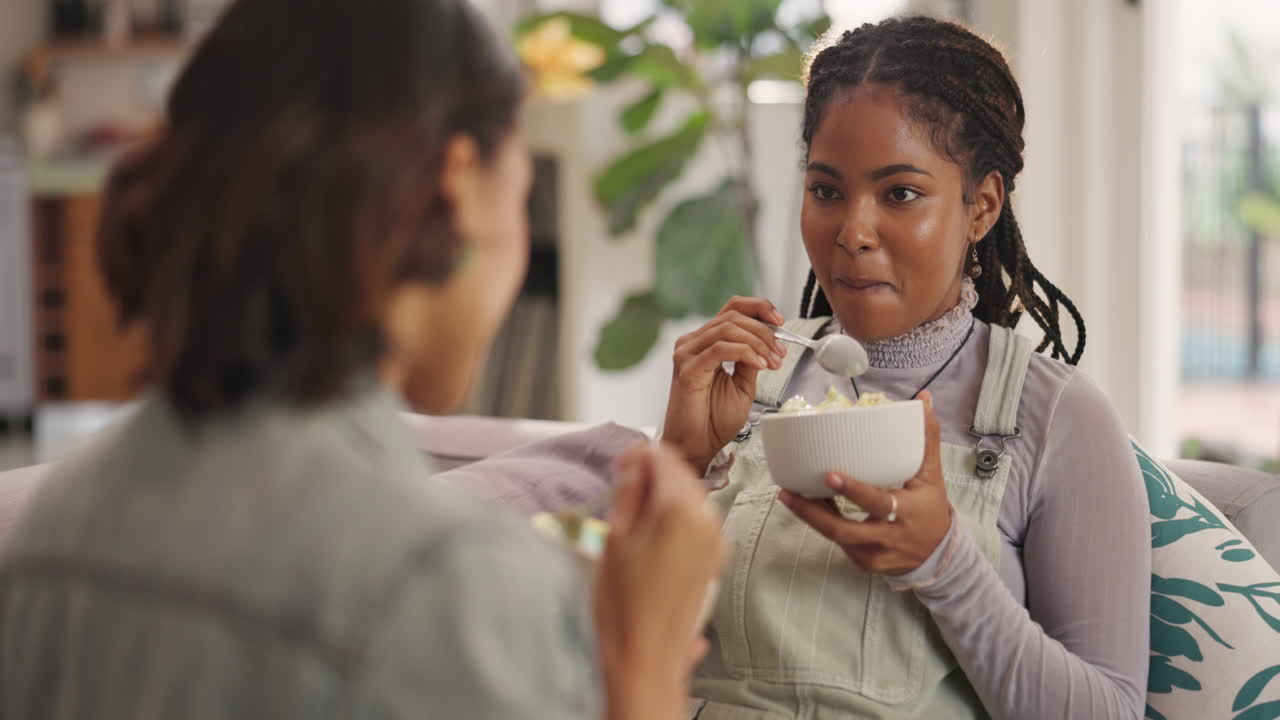 Two friends eating ice cream at home