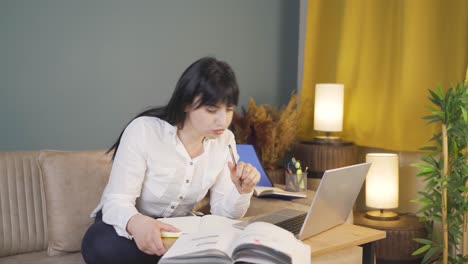 male student studying at night in laptop light.