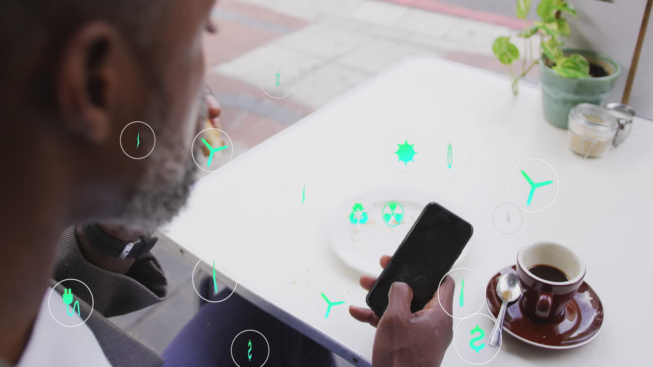 Animation of icons over african american man using smartphone