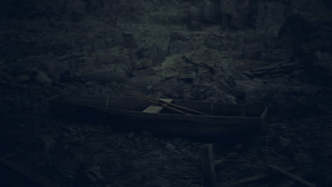 abandoned boat resting on a deserted shore under dark clouds