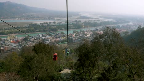 rope-way-running-through-green-forests-to-mountain-top-video-is-taken-at-Mansa-Devi-Temple-rope-way-haridwar-uttrakhand-india-on-Mar-15-2022