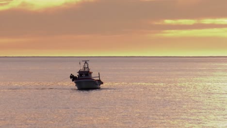 fishermen on fishing boat at dawn, checking nets