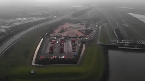 Long-line-of-cars-waiting-to-get-into-recycling-station-by-the-river-Noord