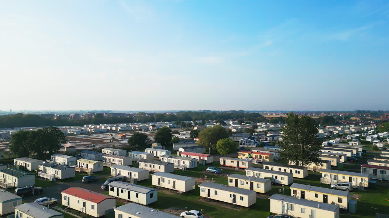 Immerse yourself in Skegness's holiday parks, capturing caravans, holiday homes, and the picturesque countryside in this aerial video on a summer evening