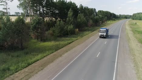 truck on a country road surrounded by trees