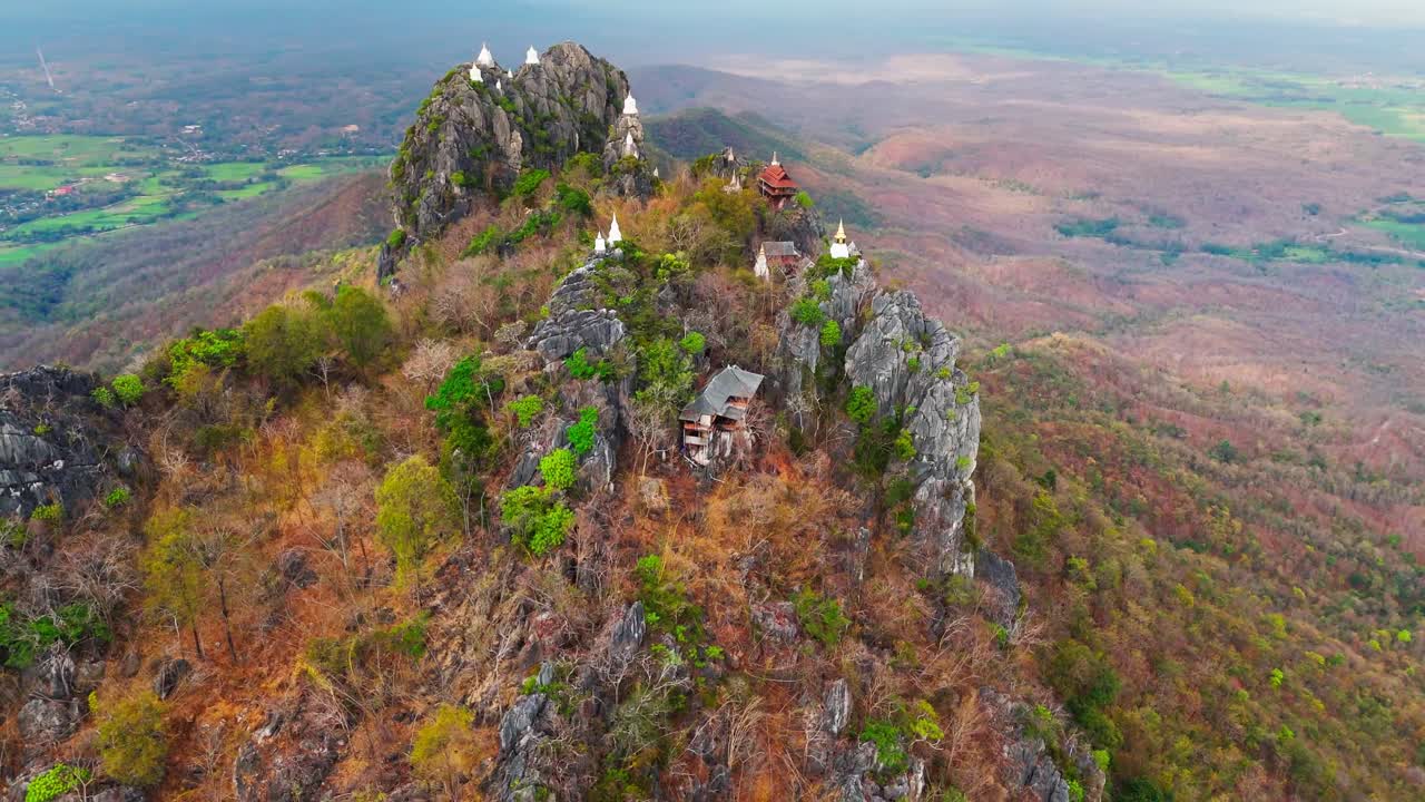 Wat Chaloem Phra Kia in Thailand, a buddhist temple high on a mountain. Slow drone pullback shot.