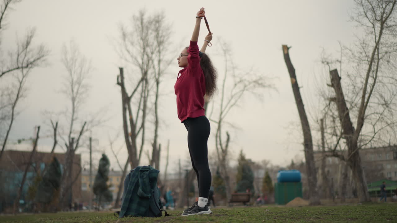 Woman Doing Plyometric Exercises Outdoors, Dynamic Female Exercising With Jumps Amidst Urban Park Scenery, Athletic Woman Performing Explosive Jumps During Vibrant Outdoor Fitness Session