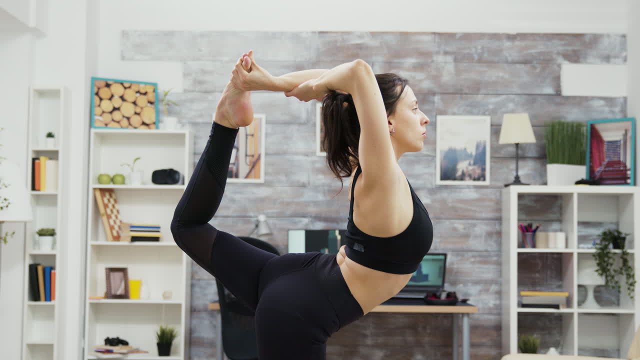 Woman practicing yoga pose at home