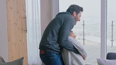 happy young couple dancing at home enjoying successful vacation having fun celebrating lifestyle on holiday with playful dance in living room