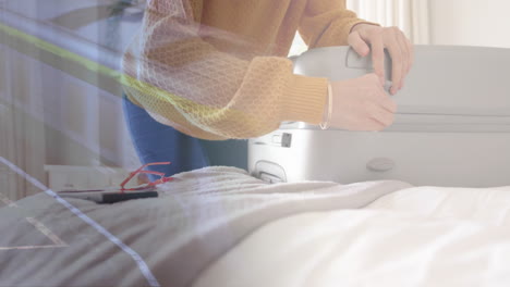 animation of caucasian woman closing suitcase in bedroom over train at station