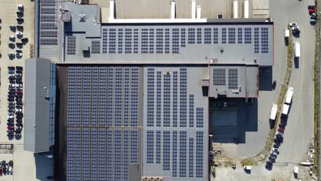 thousands of solar panels installed on rooftop of asko company warehouse in arna norway - birdseye aerial moving slowly left above solar panels