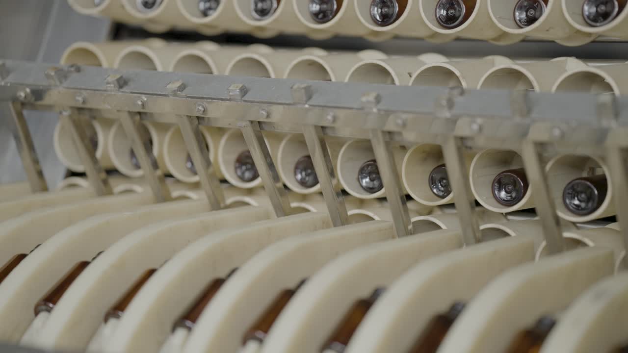Syrup Bottles getting washed in automatic machine.