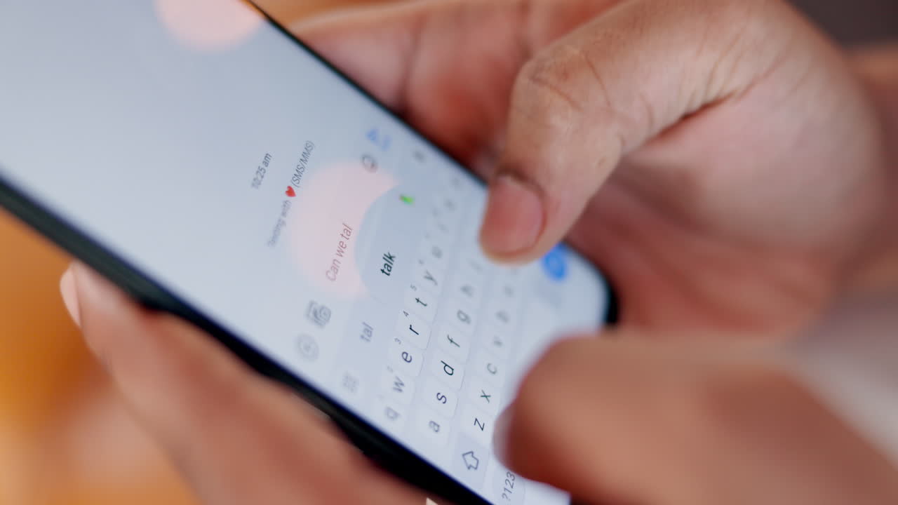 Close up of hands typing a text message on a smartphone