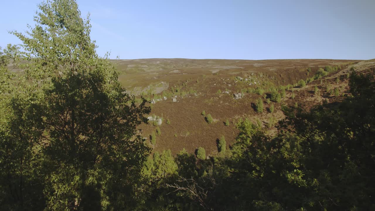 Scenic view of the wild moors of the Dark Peak District during the summer season. High altitude, elevated perspective.