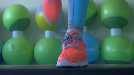woman jumping jacks in a fitness class