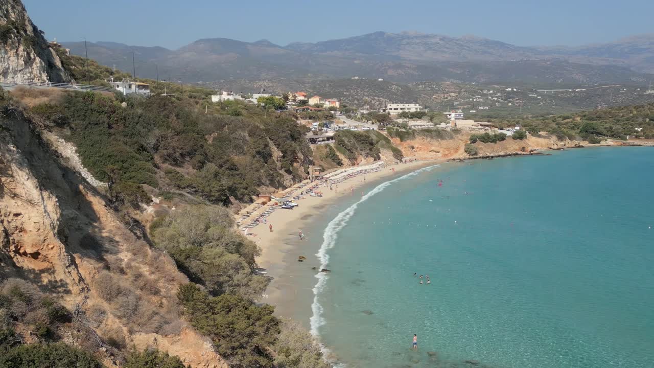 Aerial drone view of Voulisma Beach in Crete, Greece. Crystal clear turquoise waters, golden sand, and breathtaking scenery make this a true Mediterranean paradise